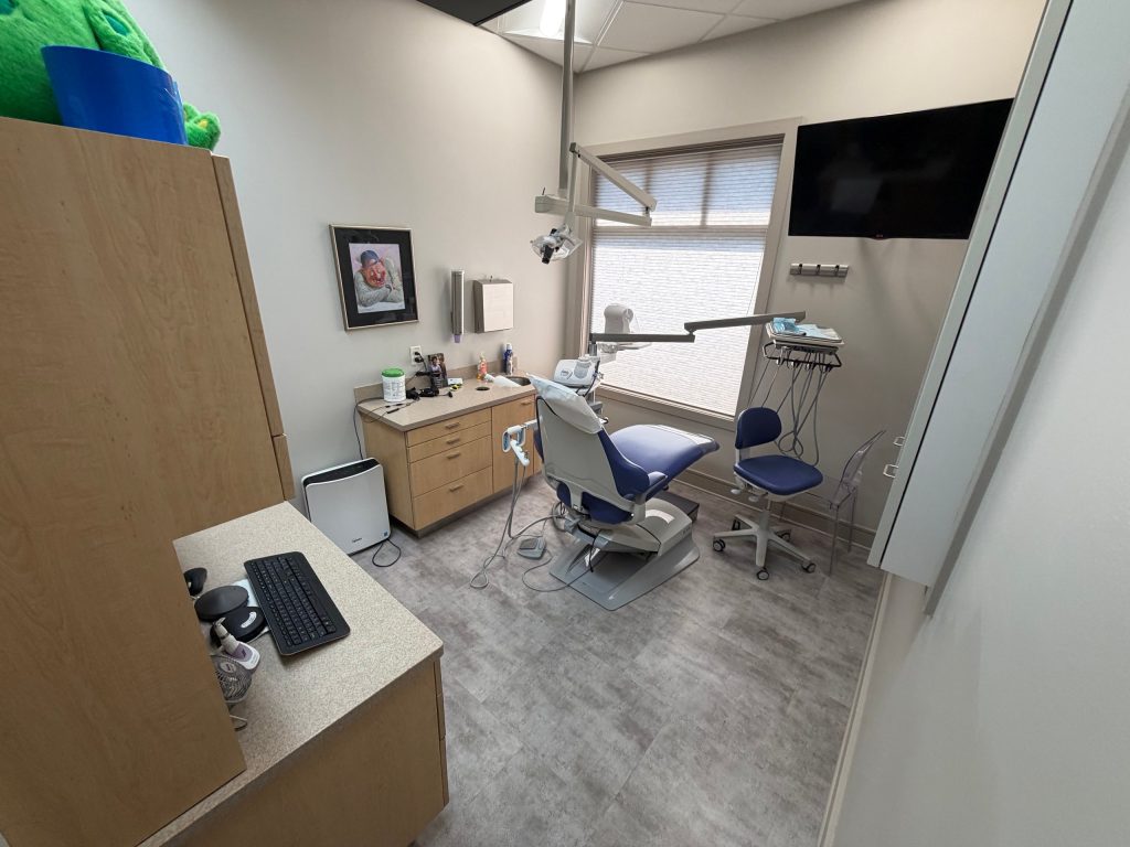 Clean dental treatment room with patient chair and counters in Lilburn, GA