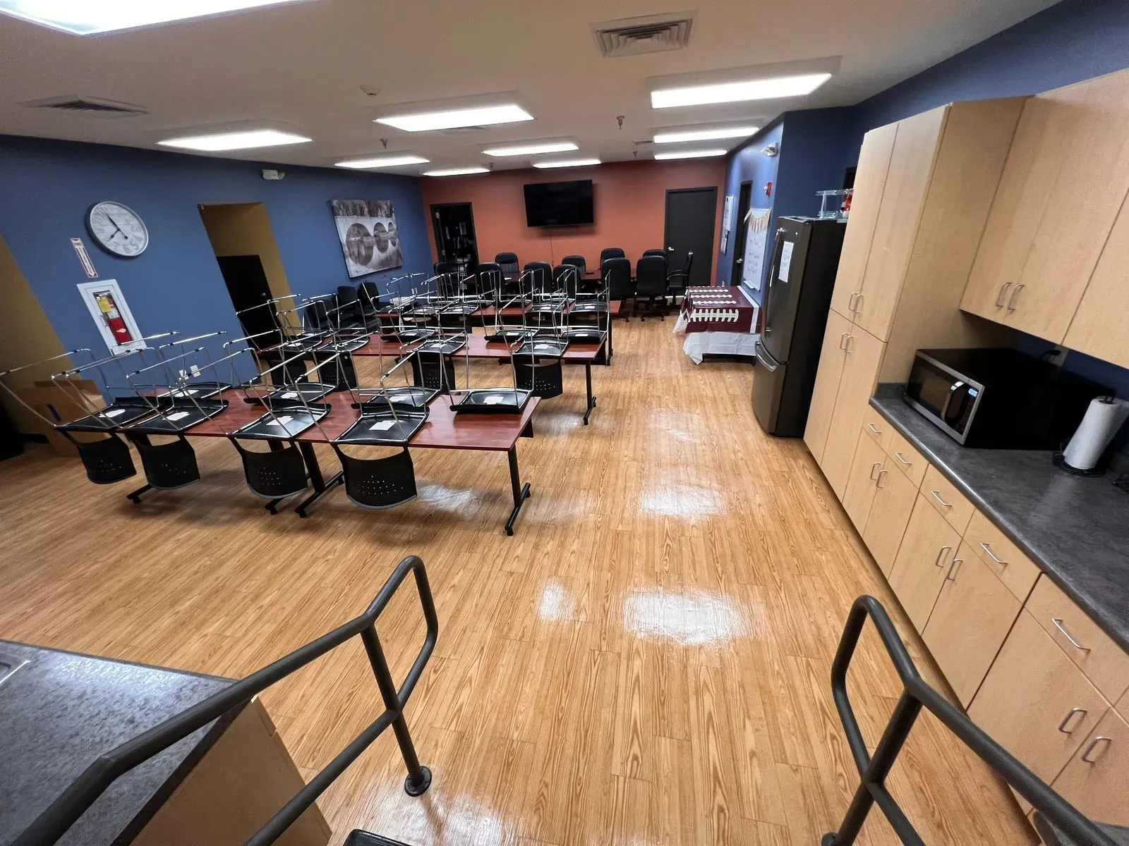Large training room with tables and a freshly cleaned floor