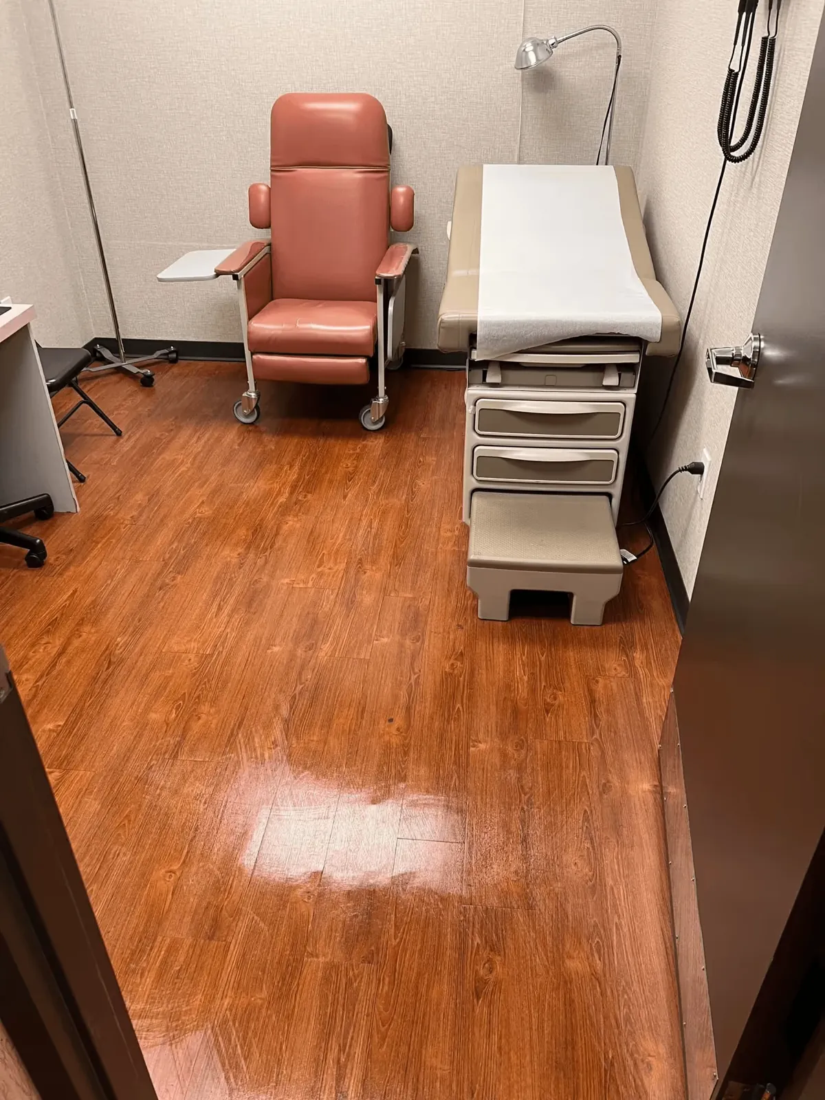Medical exam room with a cleaned and polished wood floor