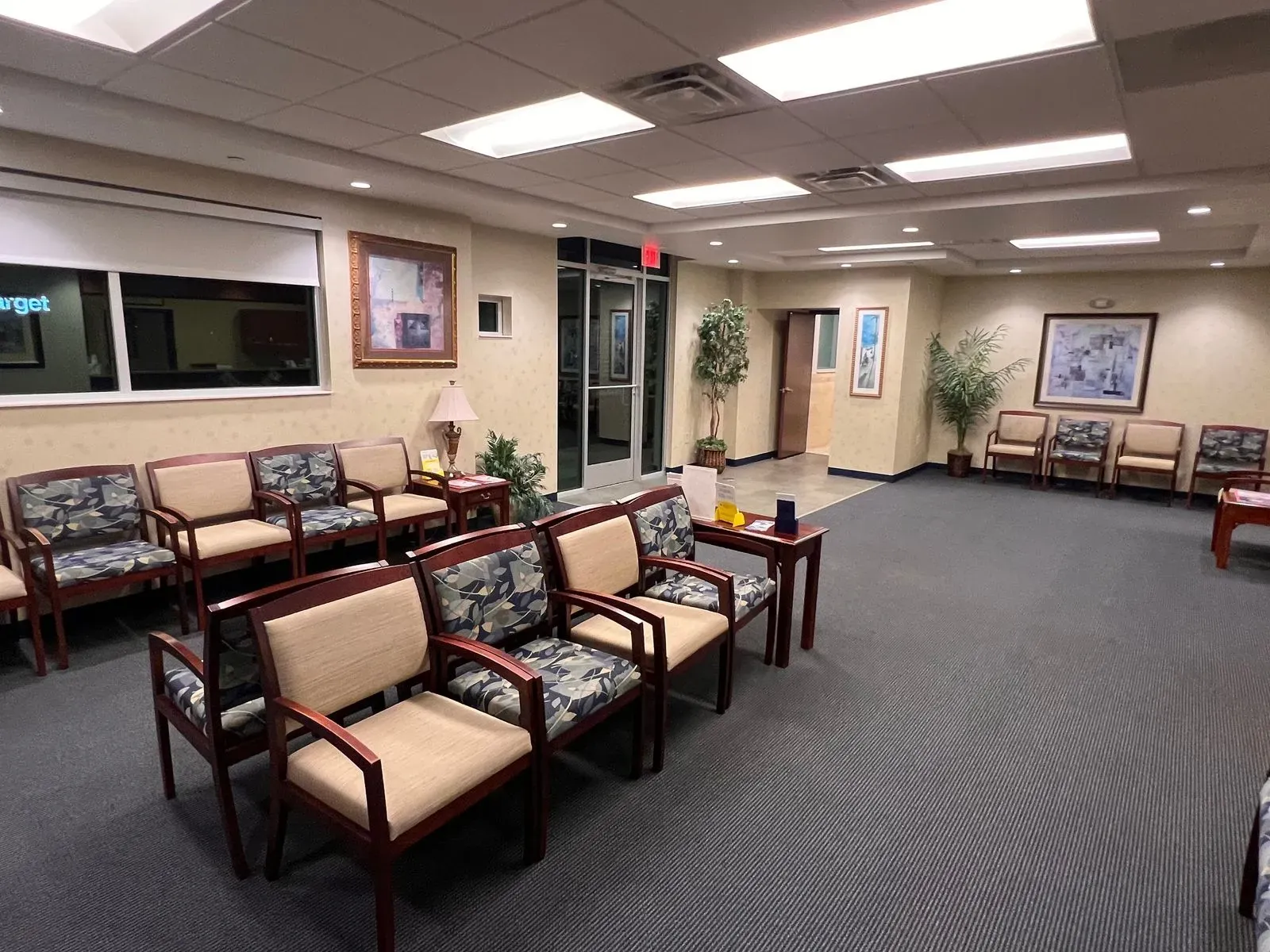 Office waiting area with vacuumed carpet and neat rows of chairs