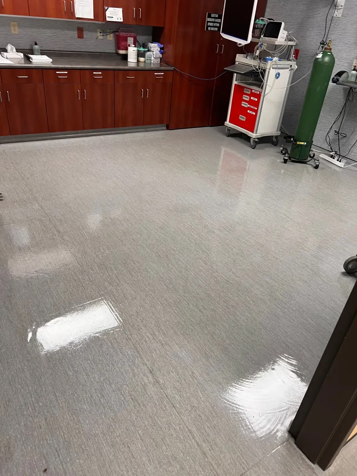 Clinic vinyl tile floor shining after strip and wax