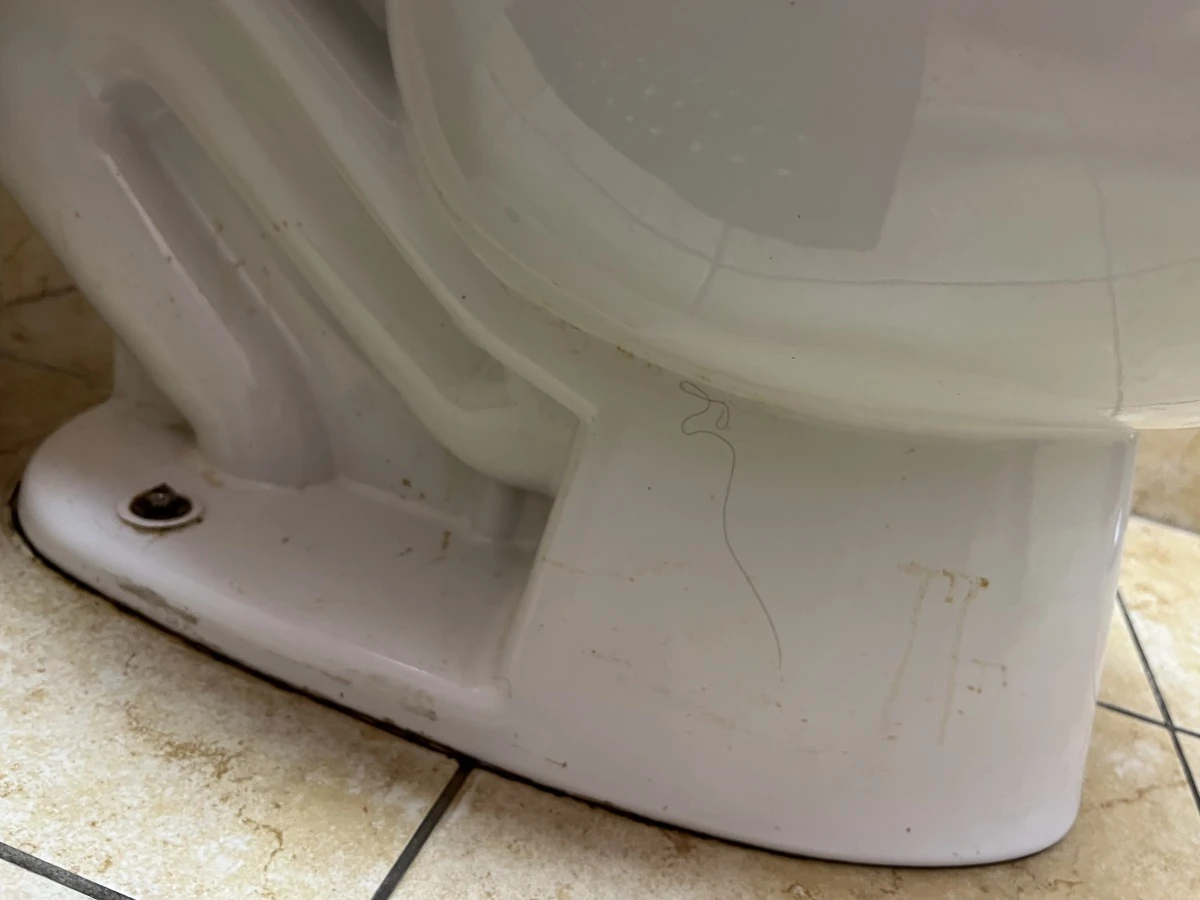 Stained toilet base and floor line in a medical office restroom before cleaning in Lawrenceville, GA
